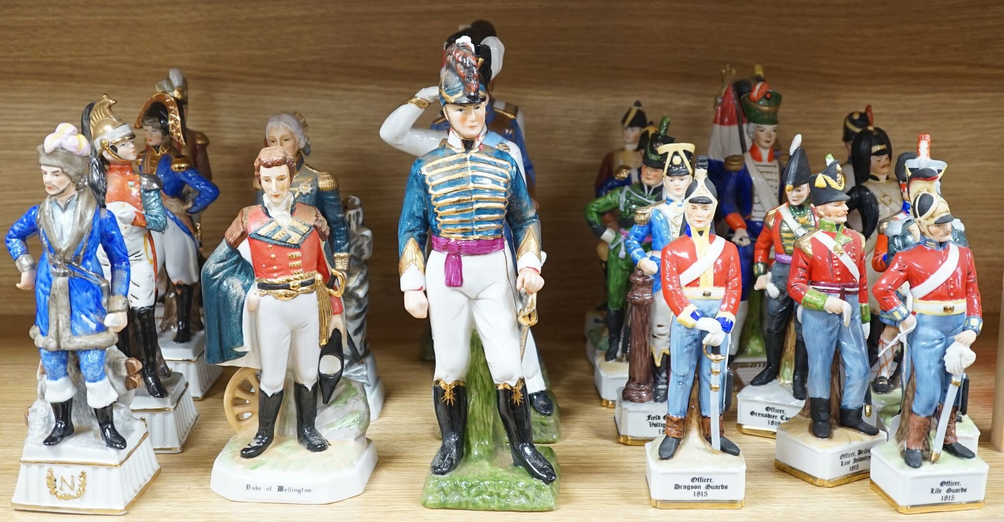 A collection of Continental porcelain figures of military soldiers, tallest 27.5cm